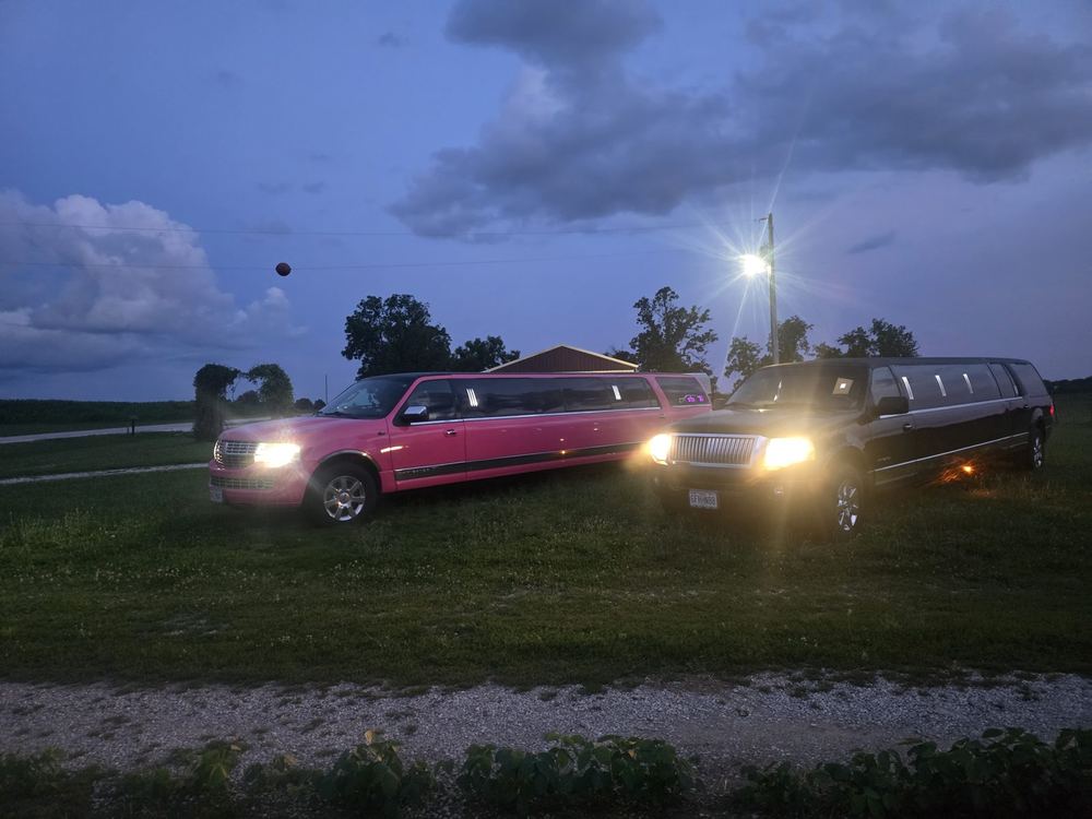 Unique Rides limo fleet at night with headlights