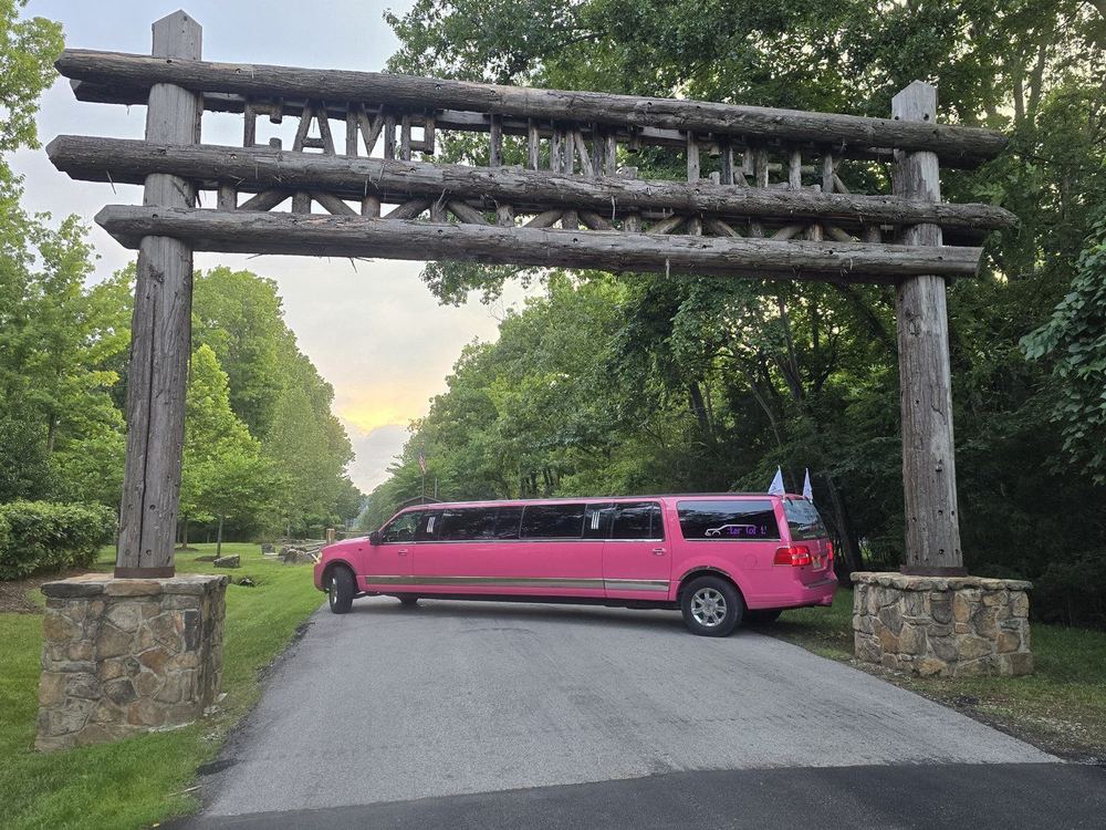 Pinkey pink limo under the Camp Long Creek arch Branson MO