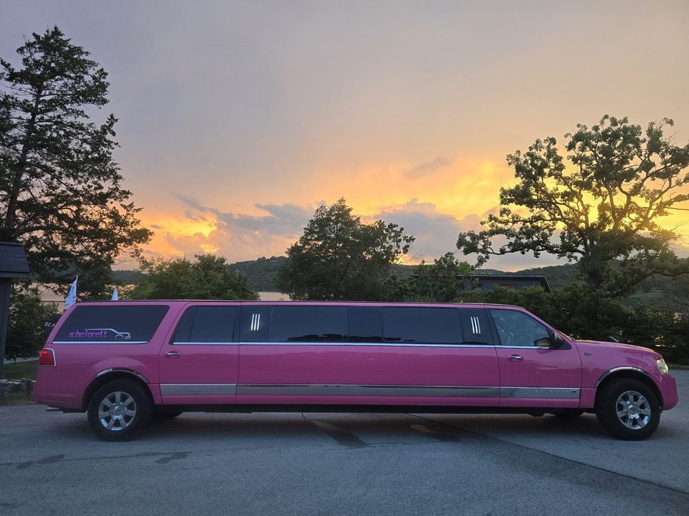 Pinkey the pink limo at a lakeside sunset near Branson MO